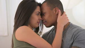 close up interracial kiss - African and Caucasian couple kissing and looking into each others eyes - HD  stock video clip