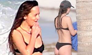 nude beach dakota - Dakota Johnson rocks a black bikini at a beach while beau Chris Martin  plays with son Moses | Daily Mail Online