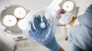 Anesthesia Patient Porn - An anesthesiologist holds a mask toward the viewer