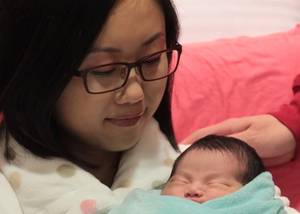 Lady Fyre Mothers Day - A mother's love: Amie looks at her newborn daughter. Photo: Bruce Yan