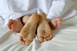 couple naked and barefoot - Couple having sex in a bed, naked male and female feet under a white  blanket. Concept of love and family, lady on her back, man on top Stock  Photo | Adobe Stock