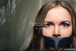 Duct Tape Mouth Girl Sexy - A beautiful girl with a gag in her mouth as a symbol of censorship. Silence