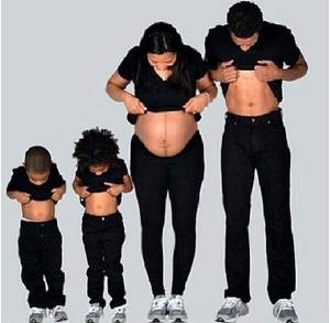 black pregnant couple - A family of soon to be All dressed Alike in All black with Jays on there  feet aka Jordans. poses as mommy dose.
