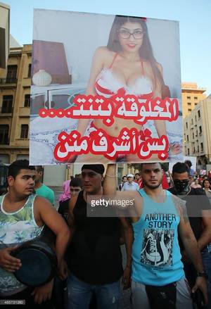 Beirut Porn - A Lebanese protester raises a poster bearing an image of Lebanese origin  Porn Star Mia Khalifa