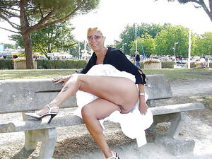 milf flashing upskirt in public - Mature blonde with no panties flashing ass in public park