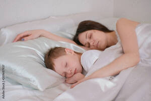 mom sleeping sex - Mom and son sleeping together. Mom hugging her son. Stock Photo | Adobe  Stock
