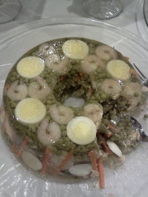 nasty asian food porn - Hard boiled eggs and shrimp suspended in a ring of lime jello, served cold.