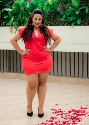 exotic chubby models - Thick Women dynamite exotic thick woman with huge legs and curvy shape  wearing high heels and pink mini skirt with matching pink blouse.