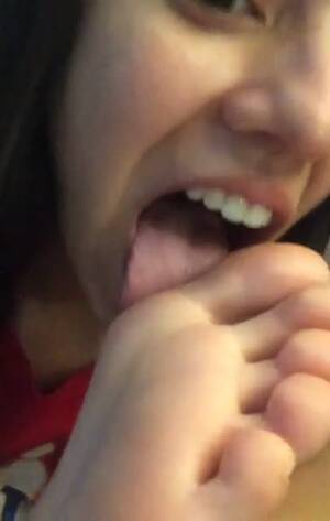 licking her own feet - Cute teenage girl licks her big toe in front of the camera - Feet9