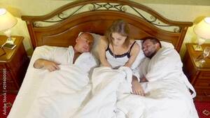 group sleep sex - blonde woman is sitting on a bed between two sleeping men and going out,  waking up after group sex in night Stock Video | Adobe Stock