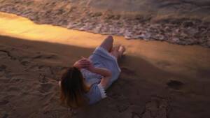 beach naked girl vidios - Top View Young Woman with Naked Legs Lying Down on Sand at Sea on the Beach  Wearing Blue Summer, Stock Video - Envato Elements