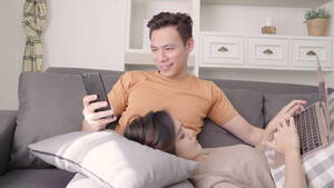 Asian Sleeping Porn - Asian couple using devices at home - Free HD Video Clips & Stock Video  Footage at Videezy!