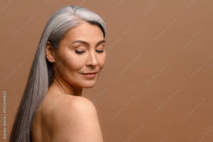 mature korean wife nude - Fotka â€žHeadshot of attractive middle-aged Asian woman with naked shoulders  and long silver hair isolated on brown, fascinating mature korean lady with  smooth skin looks down dreamily. Skincare, copy spaceâ€œ ze sluÅ¾by