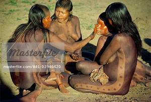 Brazilian Tribal Women Porn - A group of Xingu women applying body paint in Brazil, South America - Stock  Photo