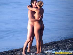 beach couple kissing naked - Nudist couple French-kissing on the beach