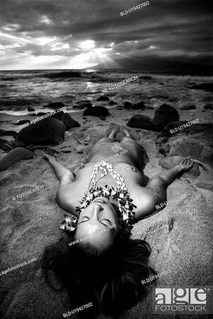 ebony nudist beach gallery - Young Caucasian nude woman wearing lei lying on beach, Stock Photo, Picture  And Royalty Free Image. Pic. BLD-U19427002 | agefotostock