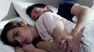 black sleeping couples - Woman not able to sleep at night hugged in bed by boyfriend feeling sad 4K -