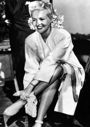 Betty Grable Pussy Shots - Betty Grable putting on a pair of nylon stockings, c. 1940.