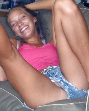 drunk teens accidental exposure - Teen pussy lip slip pic on couch with legs in air