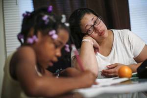 Chicago Teacher Porn Forum - Delores Leonard, right, helps her daughter Erin with her homework at the  breakfast table before heading to work at a McDonald's Restaurant in Chicago,  ...