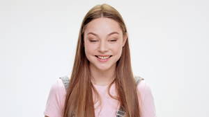 Beautiful Young Girl - Surprised young beautiful girl smiling over white background. Slow motion.  - HD stock footage