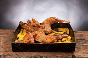 Black Food Porn - Roast cut chicken with potatoes on a wooden table. Black background. Porn  food Stock Photo | Adobe Stock