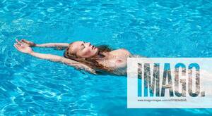 adult swim naked - Beautiful young naked woman in swimming pool, model released, , 15117024,  active, adult