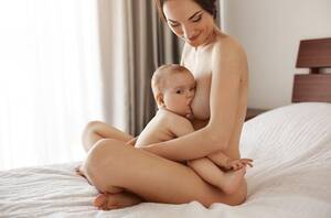 Breastfeeding Mommy Porn - Free Photo | Young attractive nude mom breastfeeding hugging her newborn  baby smiling sitting on bed at home.