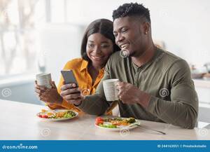 black funny videos - Cheerful Black Couple Watching Funny Videos on Smartphone during Breakfast  Stock Image - Image of browsing, home: 244163051
