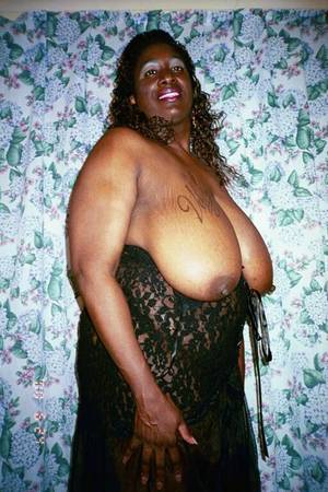 fat black mama - Fat mom with huge heavy melons strips nude and poses with smile on her face
