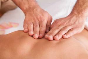massage therapy hands - Male masseuse with female client