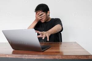 forbidden asian porn - Young asian man hiding his face with hand because shocked and embarrassed  by some porn videos or another forbidden thing he saw on the internet using  a laptop 5714741 Stock Photo at