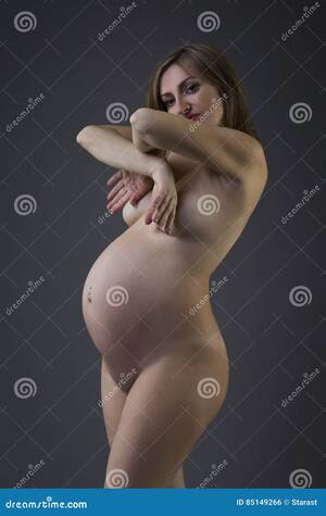 beautiful naked pregnant ladies - Beautiful Naked Pregnant Woman with Navel Piercing on Gray Studio  Background, Pregnancy Nude Concept Stock Photo - Image of erotic, body:  85149266