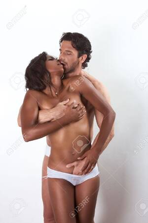 interracial undressing - Loving affectionate nude interracial heterosexual couple in affectionate  sensual hugging kissing, undressing for engage in