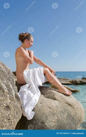 beach nude girls - Girl Sunbathing on Beach with White Towel on Her Knees Stock Image - Image  of alternative, hand: 107196741