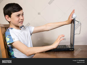 Big Boy Porn - Young boy blocking a webcam with a look of disgust