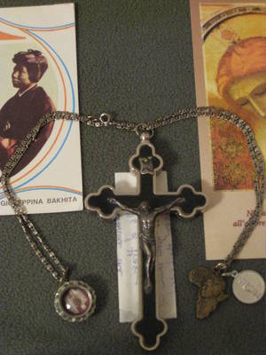 Crucifix Catholic Schoolgirl - Reliquaries of the True Cross (center), bone of St Magdalene of Canossa  (left), and 1st Class relic of St Bakhita (right)