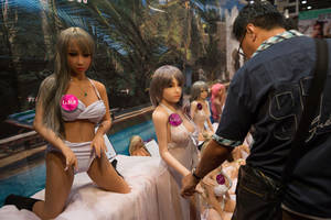 asian sex doll - A visitor browse the silicone sex doll section of the expo