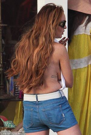 Fuck Tit Lindsay Lohan - Lindsay Lohan struggles to defy gravity in backless halterneck | Daily Mail  Online