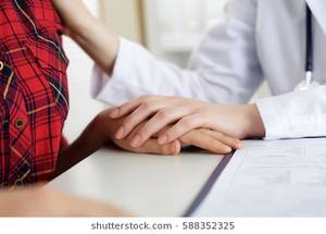 Massage Doctor Schoolgirl - Close up view of female doctor touching patient hand for encouragement,  empathy, cheering,