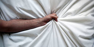 harmful effects of anal sex - Arm reaching out in a bed