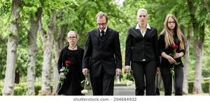 Grave Yard Hispanic - Family on cemetery walking down alley at graveyard with roses