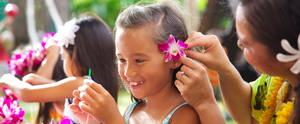 girl nudism fun - ... A Cast Member tucks a fuchsia orchid behind a little girl's ear as she  threads flowers ...