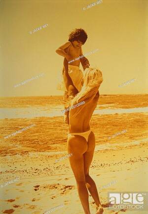 mature nudist beach moms - Semi-nude mother holding daughter in the air at the beach. Yellow cast,  Stock Photo, Picture And Rights Managed Image. Pic. MXX-PE07C0088 |  agefotostock