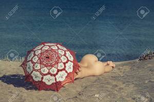 beach nude girls - Beautiful Naked Female Lies On The Beach Under A Red Umbrella. Girl On The  Sand Under The Umbrella Stock Photo, Picture and Royalty Free Image. Image  81155101.