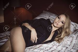 blonde babe posing naked - Beautiful Blonde Girl Posing Lying On Bed With Nude Legs, Unbuttoned Blue  Shirt And Fashion Make-up. She Is Looking In Camera With Charming And  Relaxed Expression Stock Photo, Picture and Royalty Free