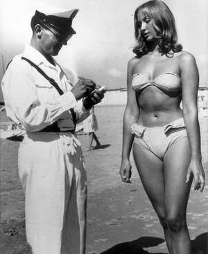 euro topless beach - A police officer issuing a woman a ticket for wearing a bikini on an  Italian beach, 1957. At the time the bikini was banned from beaches and  public places on the French