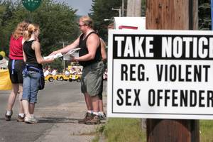 Candace Flynn Moving Porn - A man hands out information to neighbors, warning them to stay away from  the home of a sex offender in the neighborhood. Gregory Rec/Portland Press  Herald ...