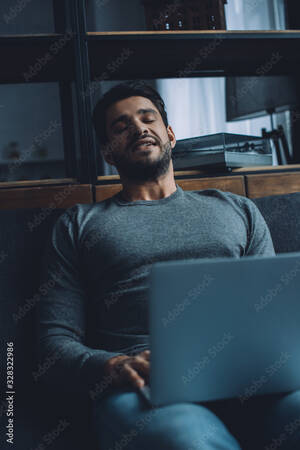 Masturbation Watching Computer Pornography - Handsome young man masturbating while watching pornography on laptop on  sofa in living room Stock Photo | Adobe Stock