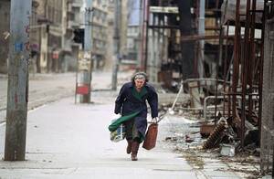 Bosnian Street Porn - A Bosnian woman rushes down an empty sidewalk past war-destroyed shops in  one of the worst sections of the so-called 'Sniper Alley. April 8, 1993 in  Sarajevo. [991x648] : r/HistoryPorn